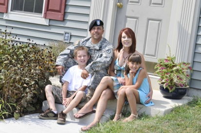 military-family-in-front-of-home